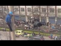 Drunk man hangs upside down from electricity wires in China