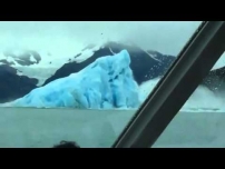 Iceberg flips over, amazing tourists